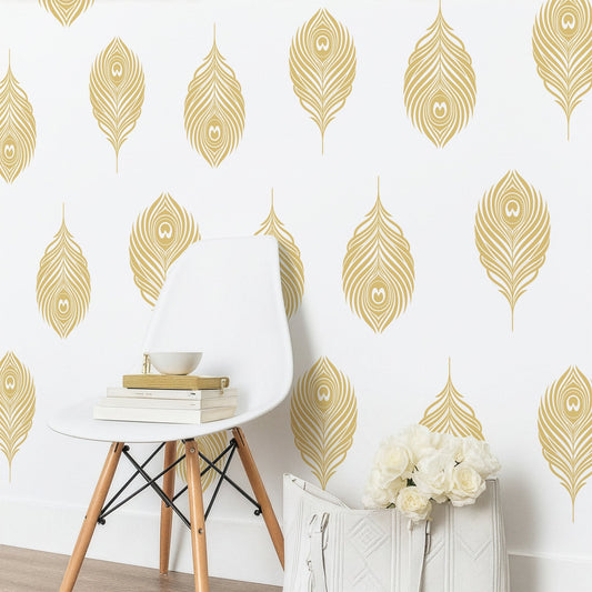 Gold peacock feather wall decals styled on a white wall above a modern chair and bouquet of roses