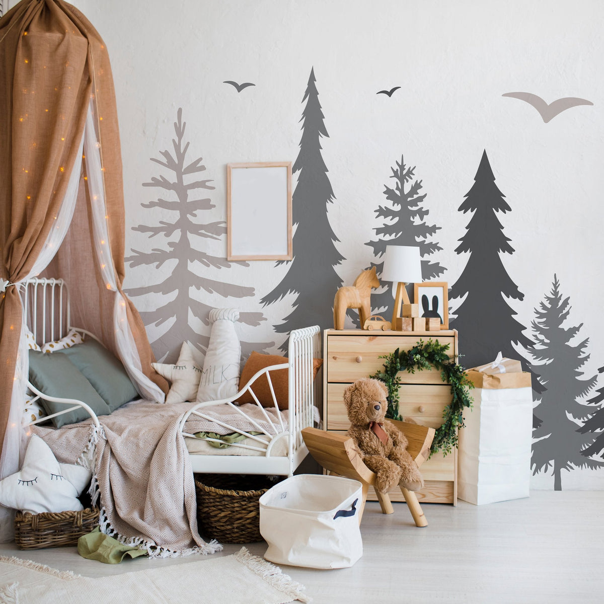 Pine forest wall decal arranged on a feature wall in a playroom