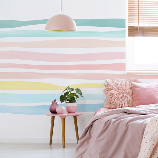 Watercolor stripe wall decals installed on a pastel nursery accent wall with soft painted horizontal bands
