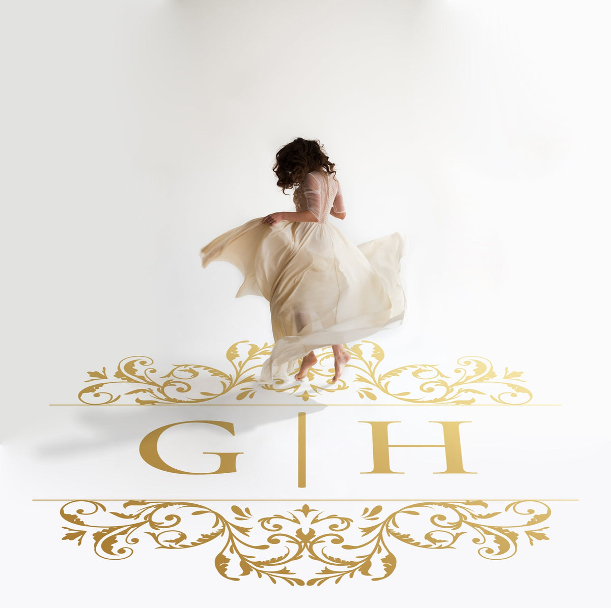 Ornate Flourish Monogram Dance Floor Decal for Wedding in gold on a white wedding dance floor