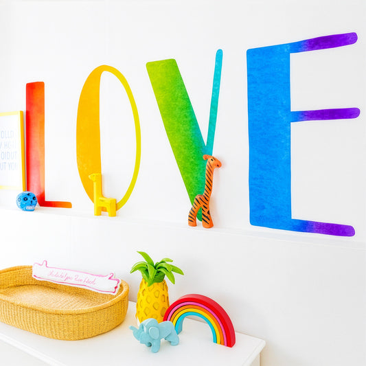Rainbow LOVE Wall Decal installed on a styled nursery wall