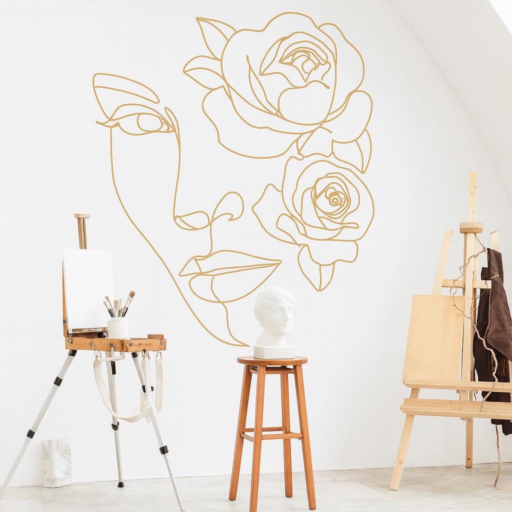 Woman Face Wall Decal displayed in a styled space